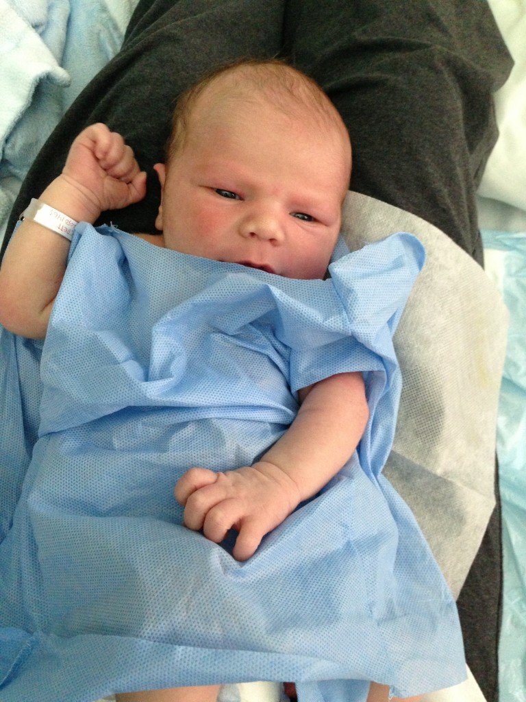 Our sweet boy showing off the paper shirt the hospital gave him!