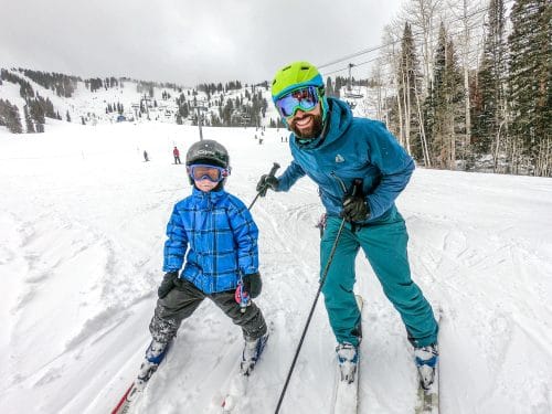 man and boy skiing