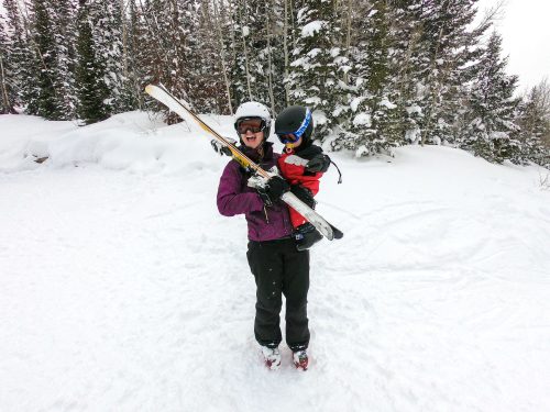 holding baby while ski