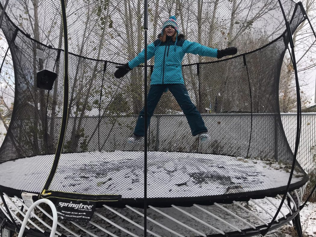 Girl on a snowy trampoline