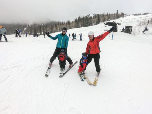 two babies skiing