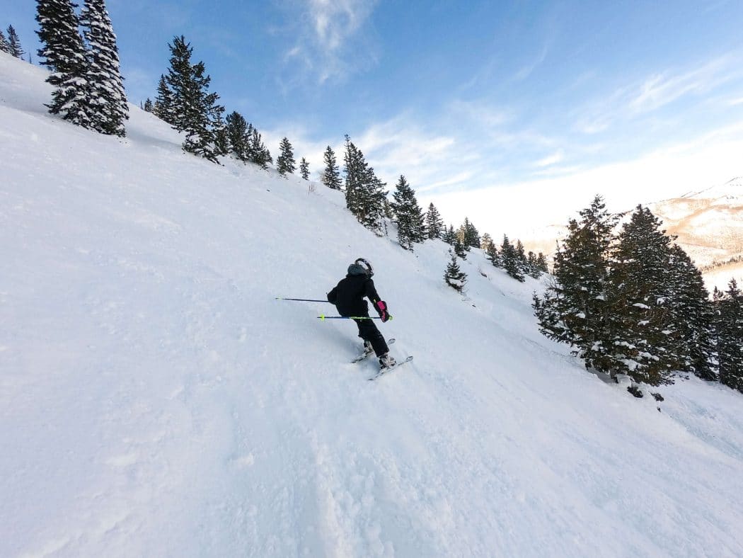 girl skiing steep terrain