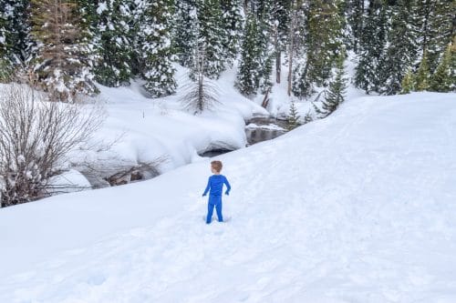 boy playing in the snow wearing base layers