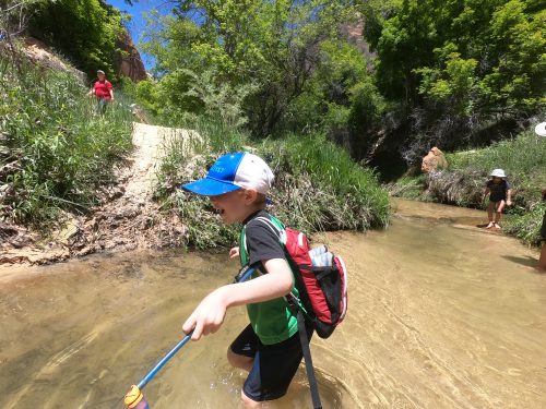 little boy with hydration pack