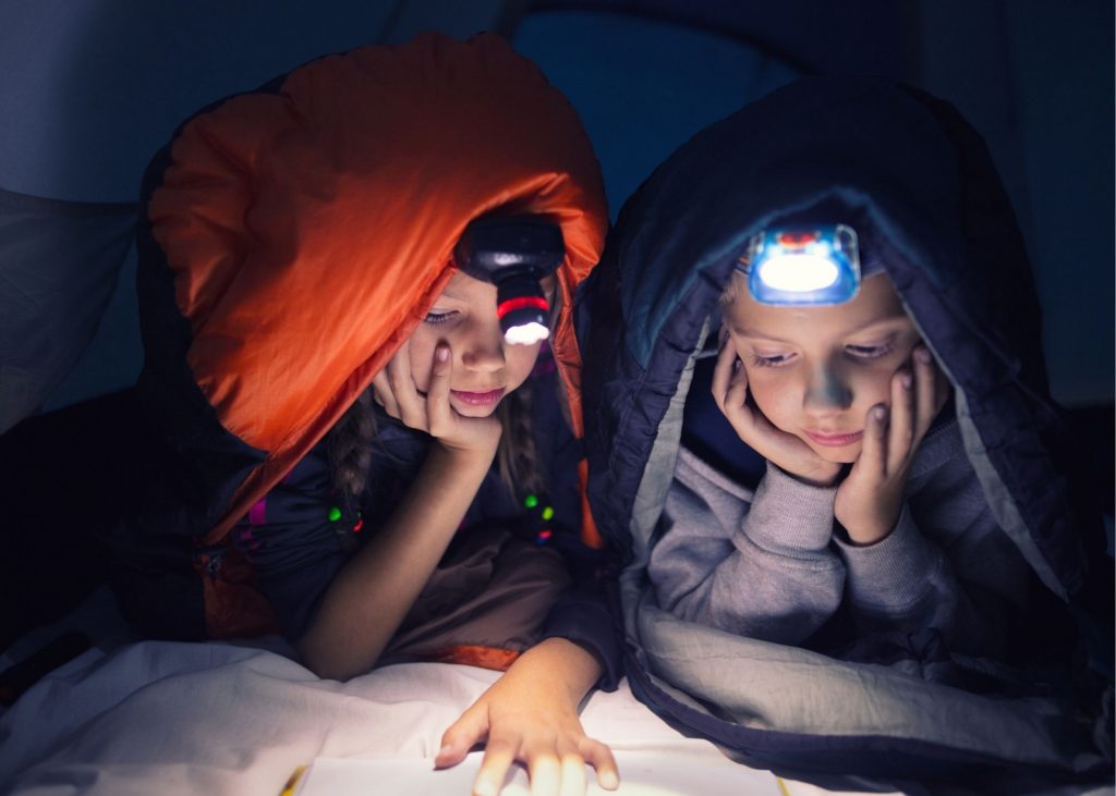 kids with headlamp in tent