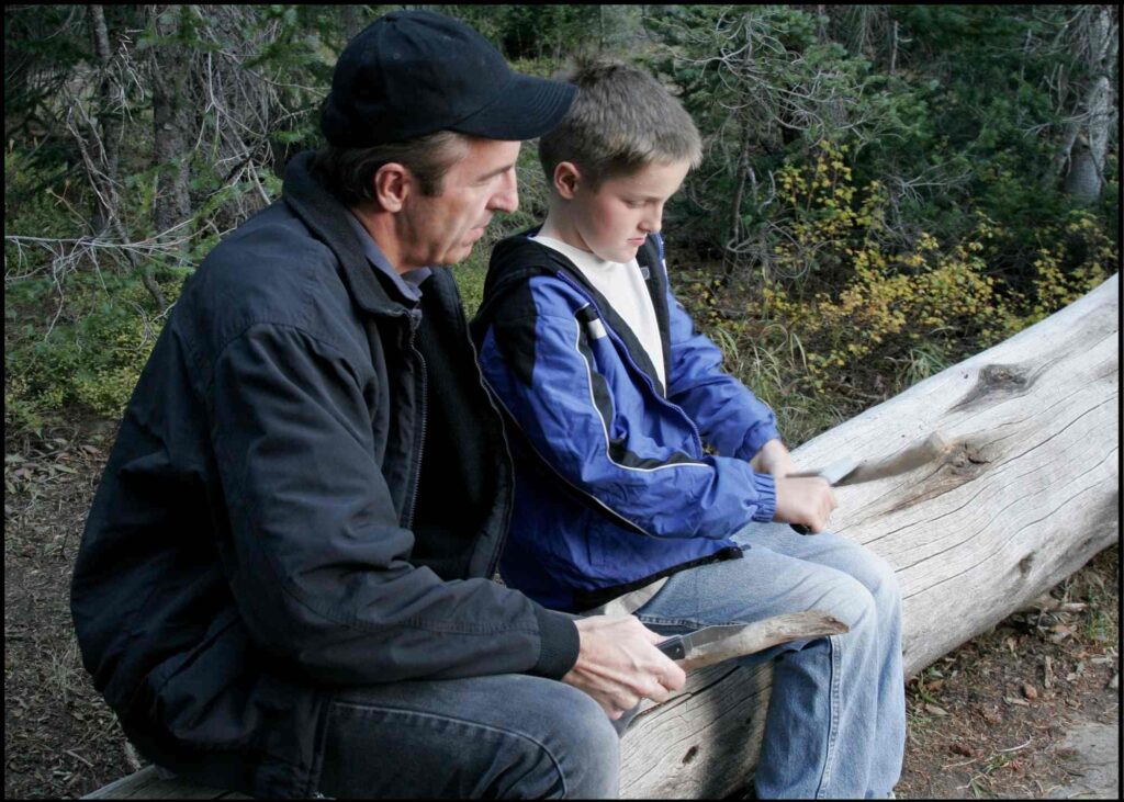 boy using a pocket knife