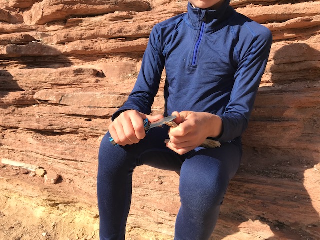 boy cutting with a pocket knife