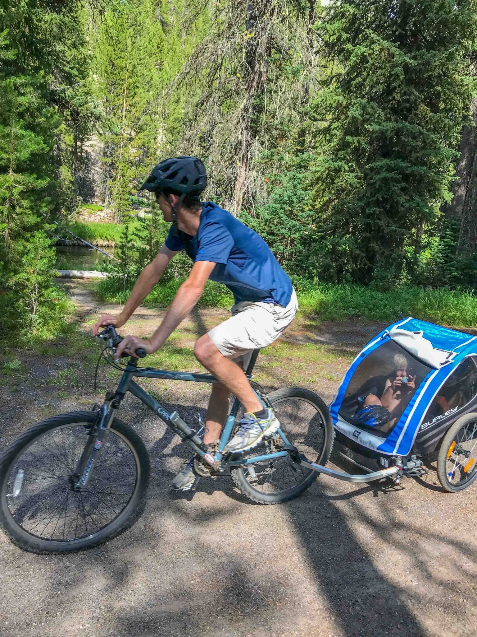 dad and baby biking through Yellowstone