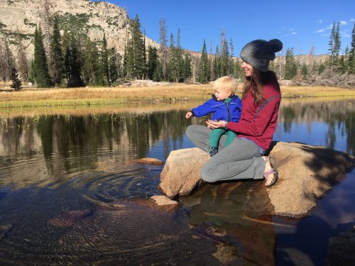 baby playing with rocks while camping