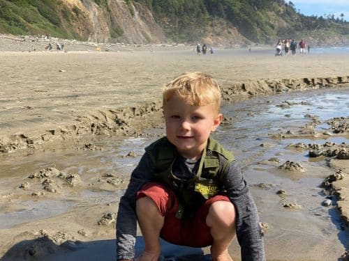 little boy playing on the beach