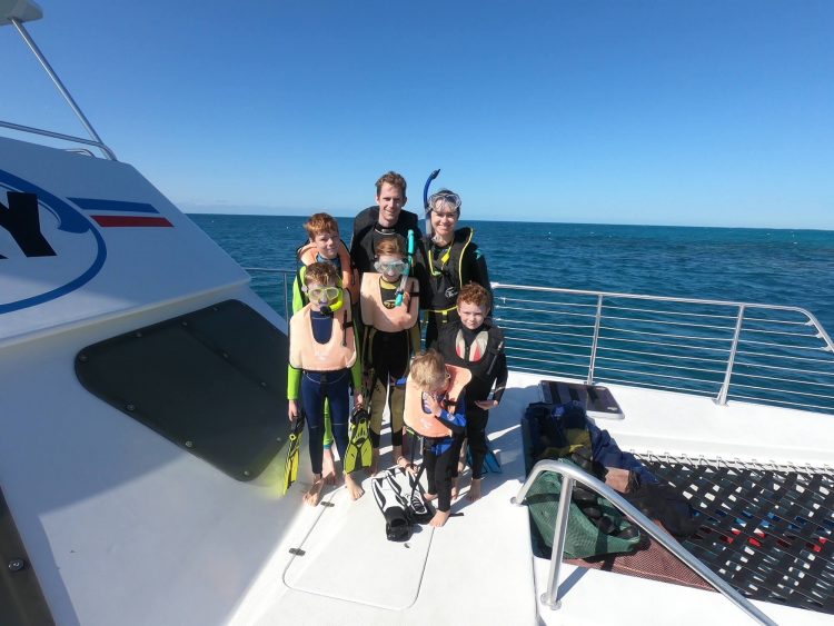 family wearing wetsuits