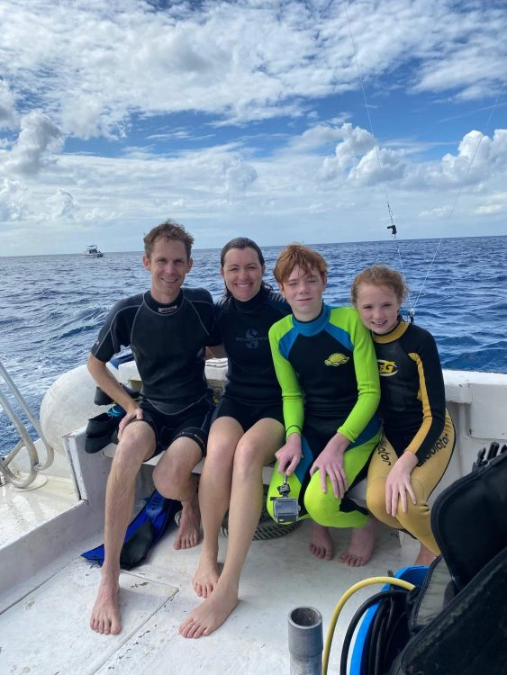 family wearing wetsuits