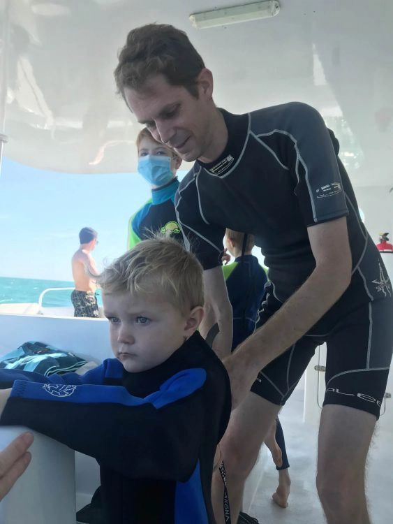 little boy in baggy wetsuit