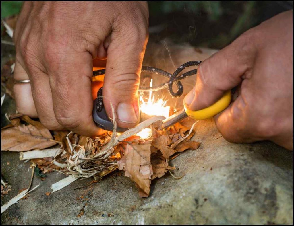 Kindling a fire with a flint